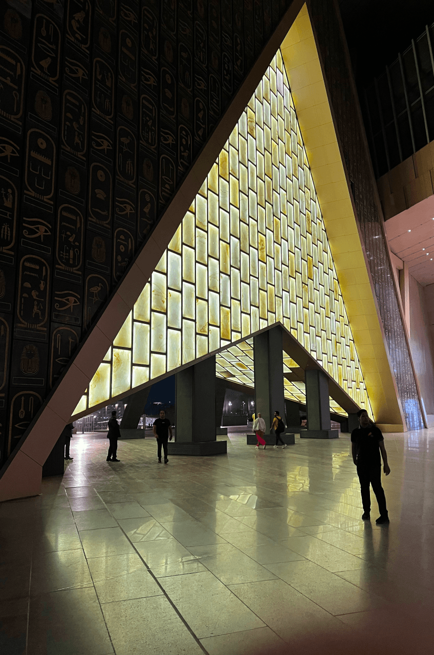The hieroglyph-carved entrance hall of the Grand Egyptian Museum in Giza, lit at night