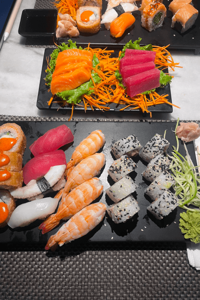 Platters of sushi, sashimi and maki rolls on a table
